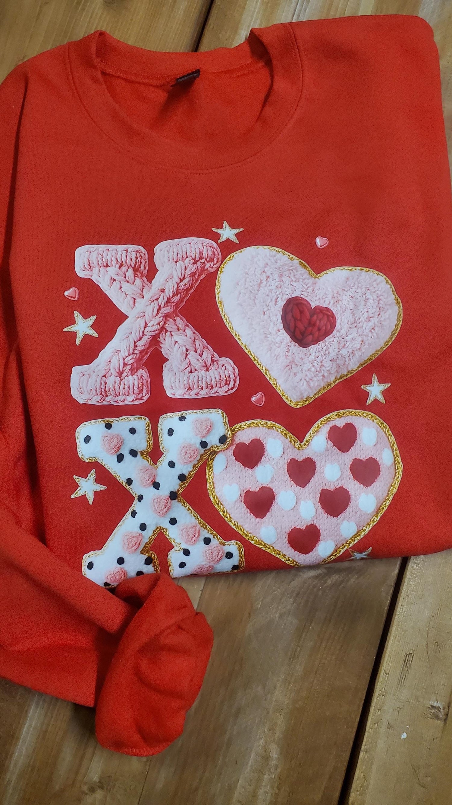 Red sweatshirt featuring faux crochet XO letters and heart shapes with a yarn-textured Valentine design in pink, red, and white tones, Girlfriend Gift, Valentine gift for her, Angela Jasmina, AJ Blanks