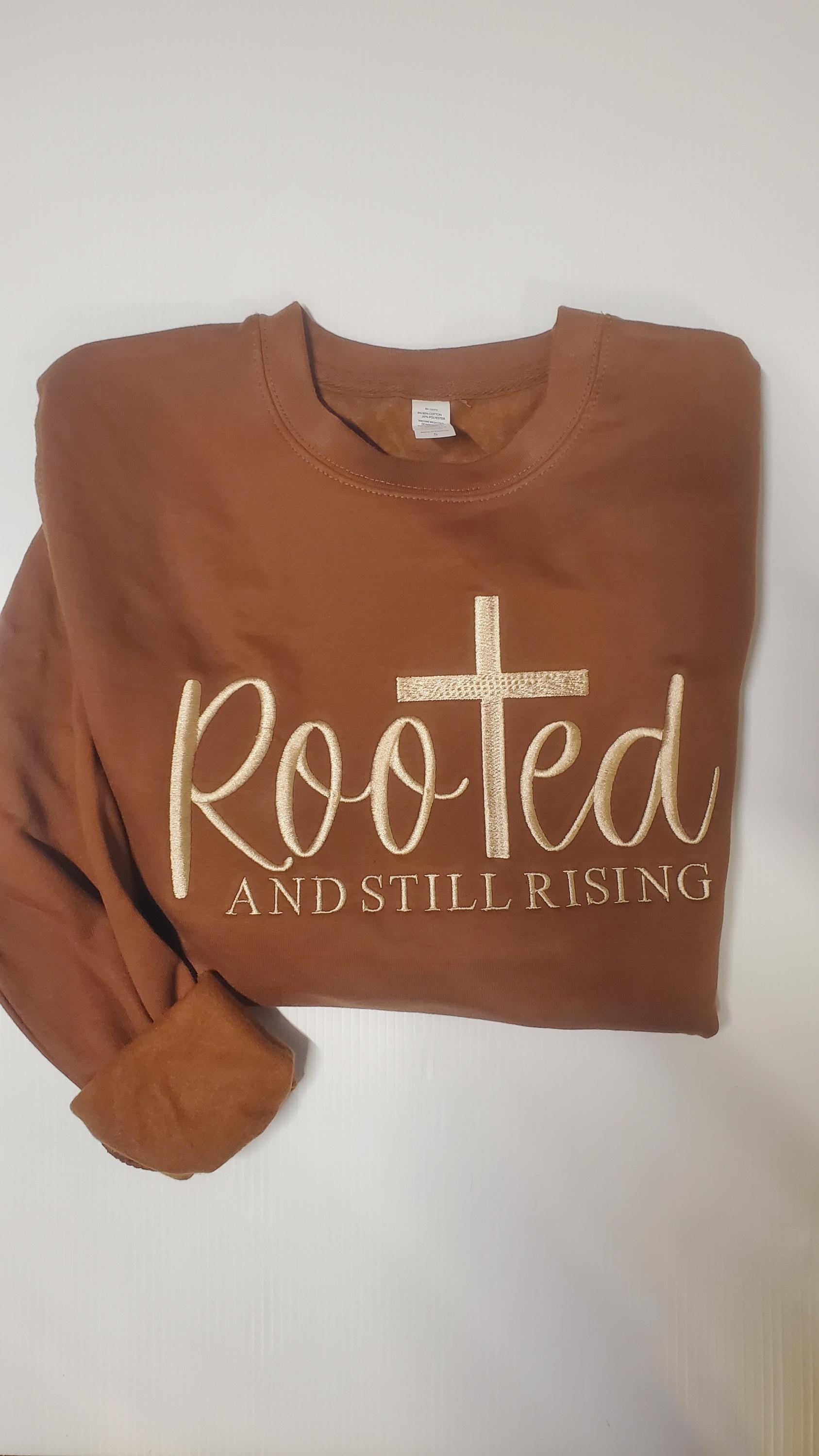 christian sweatshirt, clothing jesus gift, gift spiritual wear, wear blessed pullover, pullover church clothing, gift, gift religious wear, wear cotton sweater, sweater jesus king, king blessed mom, spiritual present,faith sweater, Easter Shirt
Brown crewneck sweatshirt featuring a faith inspired design with a cross and the words Rooted and Still Rising, made on a super soft comfortable sweatshirt available in multiple colors, inspirational Christian women’s pullover Angela Jasmina AJ Blanks